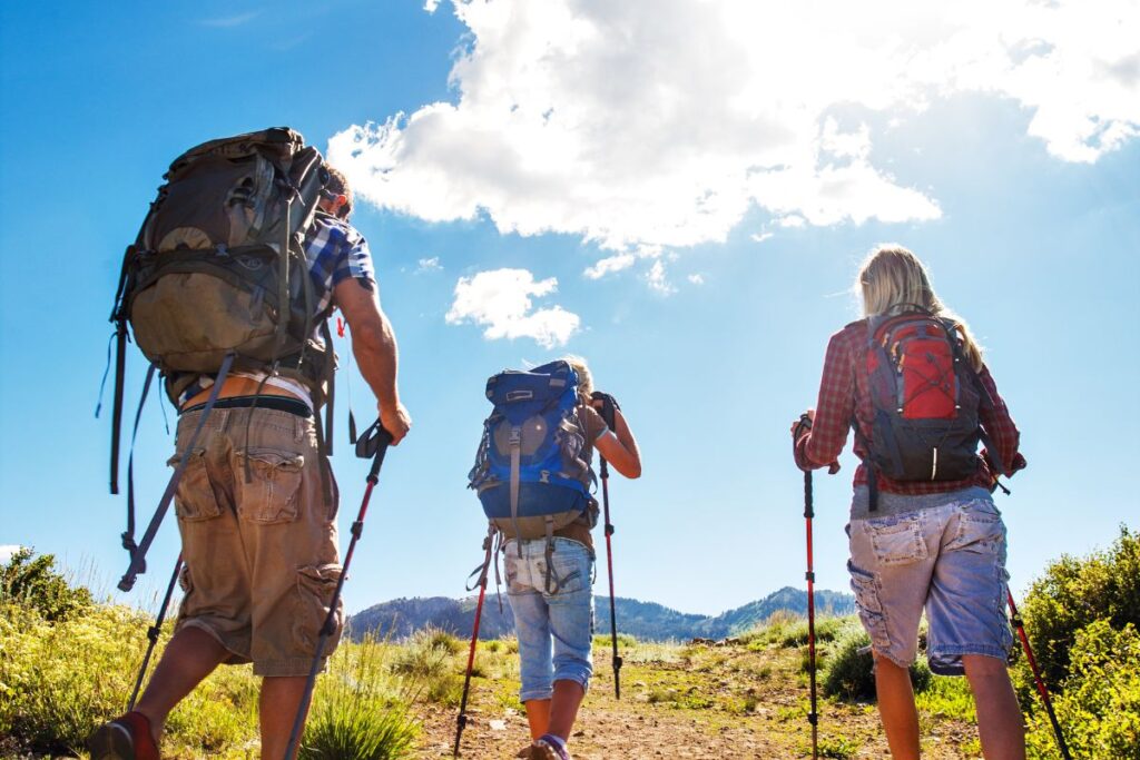 Randonneurs faisant une pause en montagne à côté de leurs sacs à dos ouverts