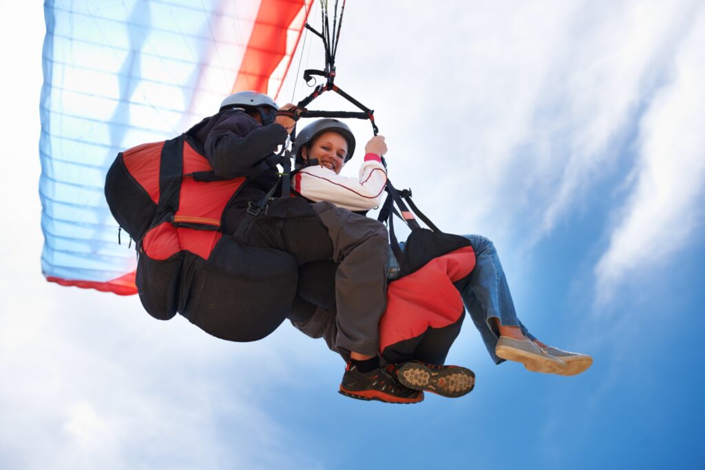 Aile de parapente colorée au-dessus des sommets enneigés de Haute-Savoie