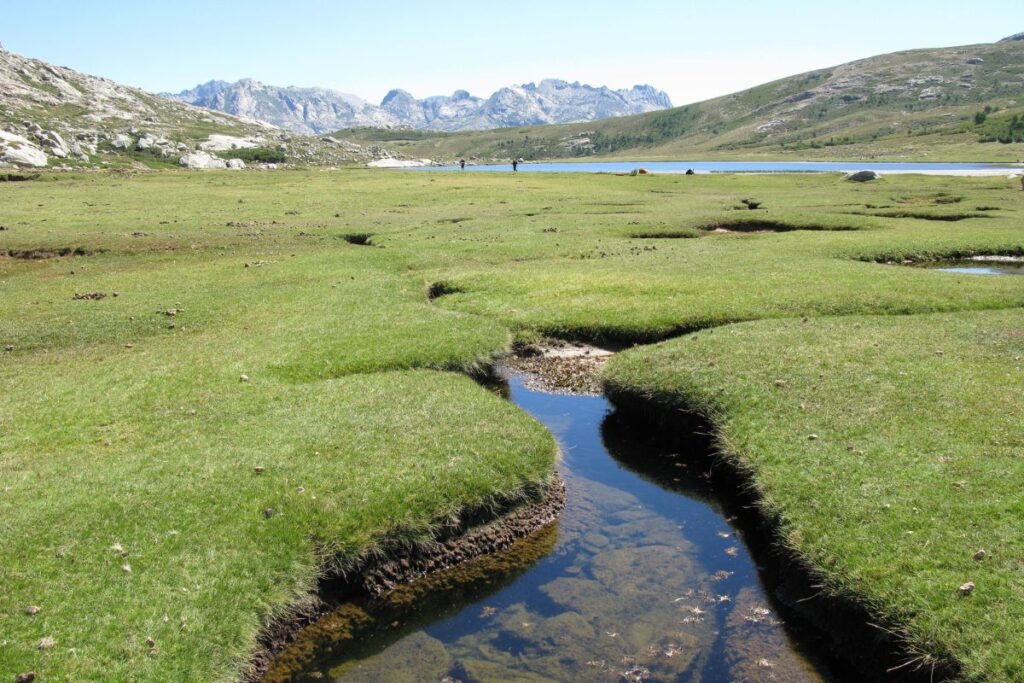Randonneurs sur un sentier rocheux et escarpé du GR20 dans le nord de la Corse