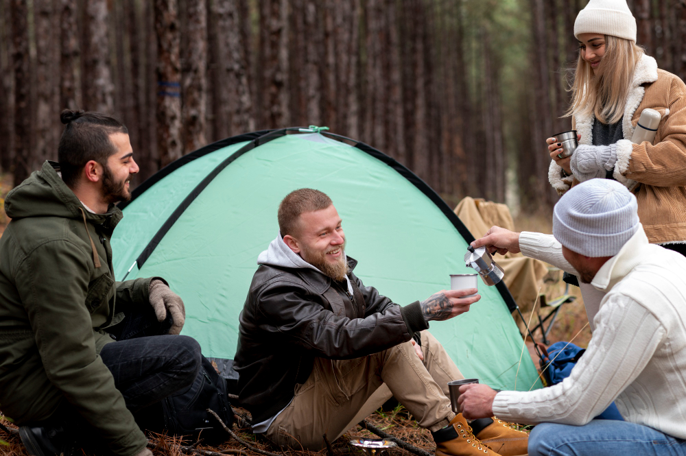 Tentes et hébergements de camping dans une vallée de montagne entourée de sommets